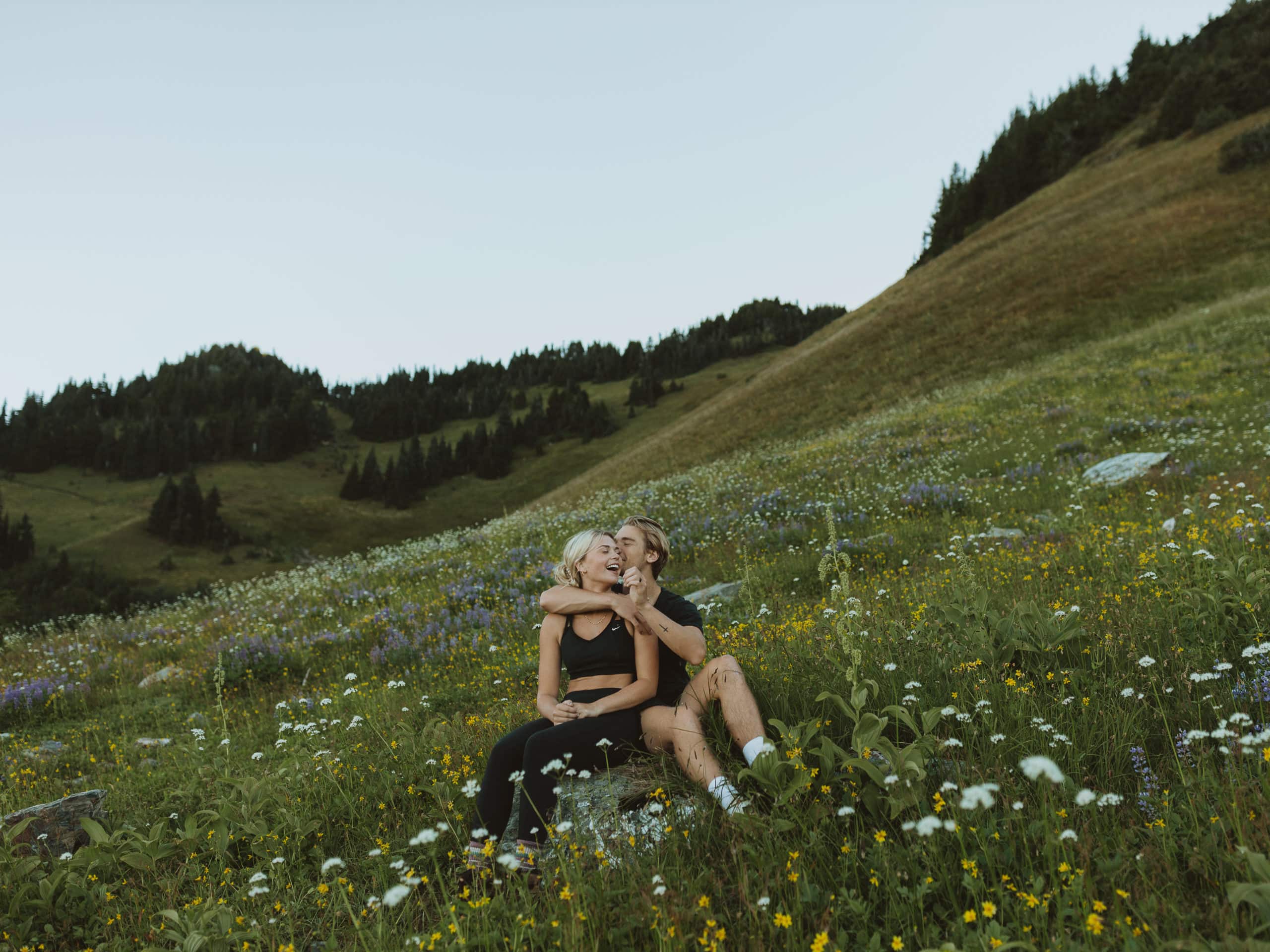 couple sharing a kissing in the wildflowers on their elopement day