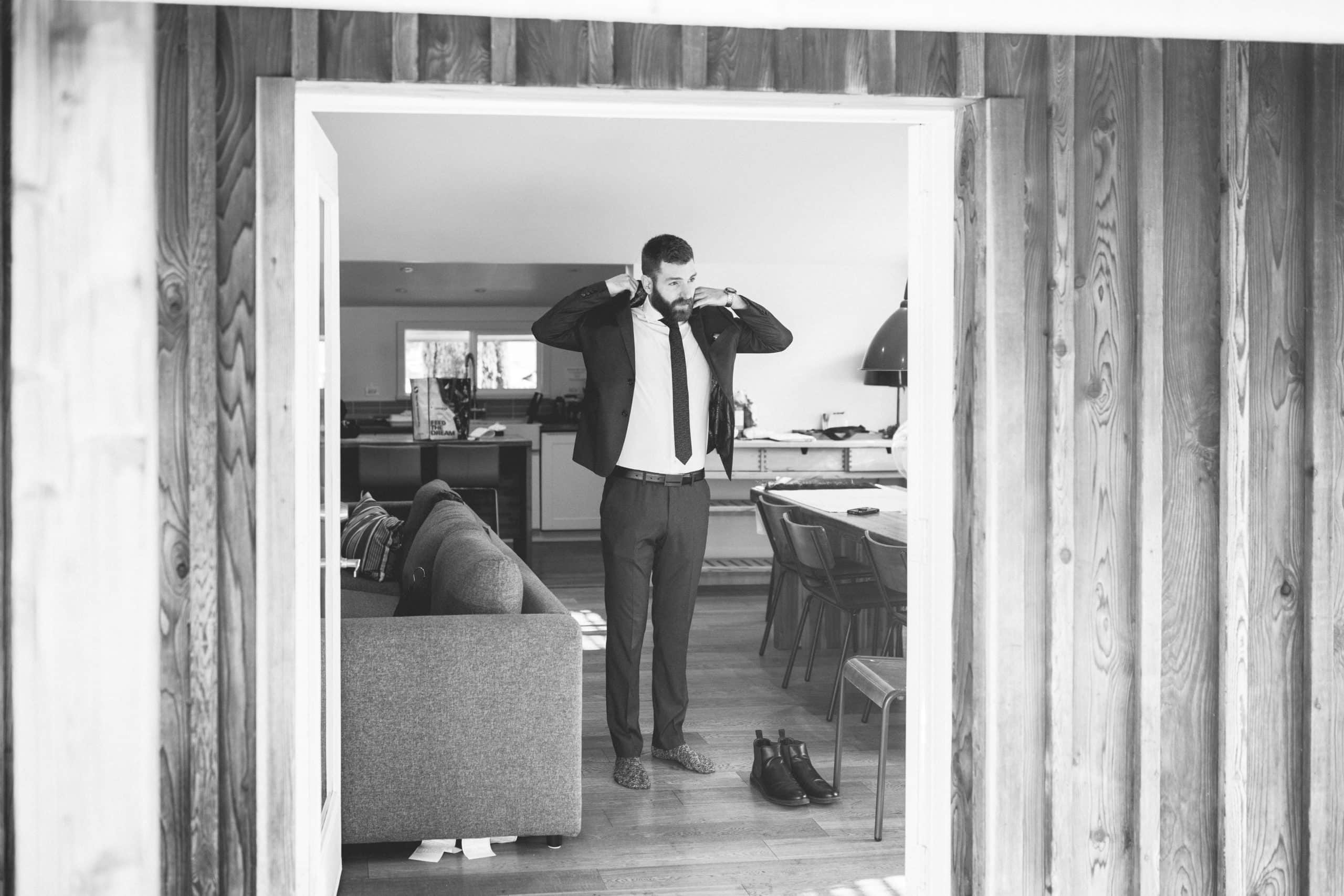 groom getting ready for elopement at an airbnb in Whistler