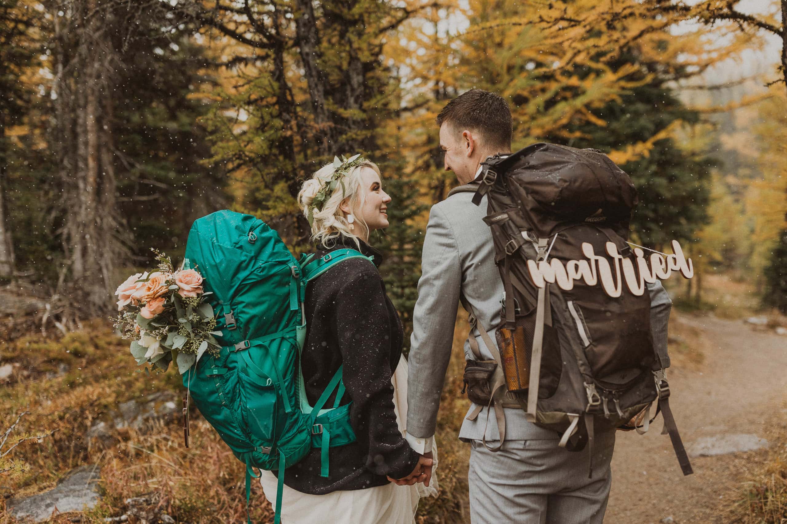 couple hiking through the larches at moraine lake on their elopement day