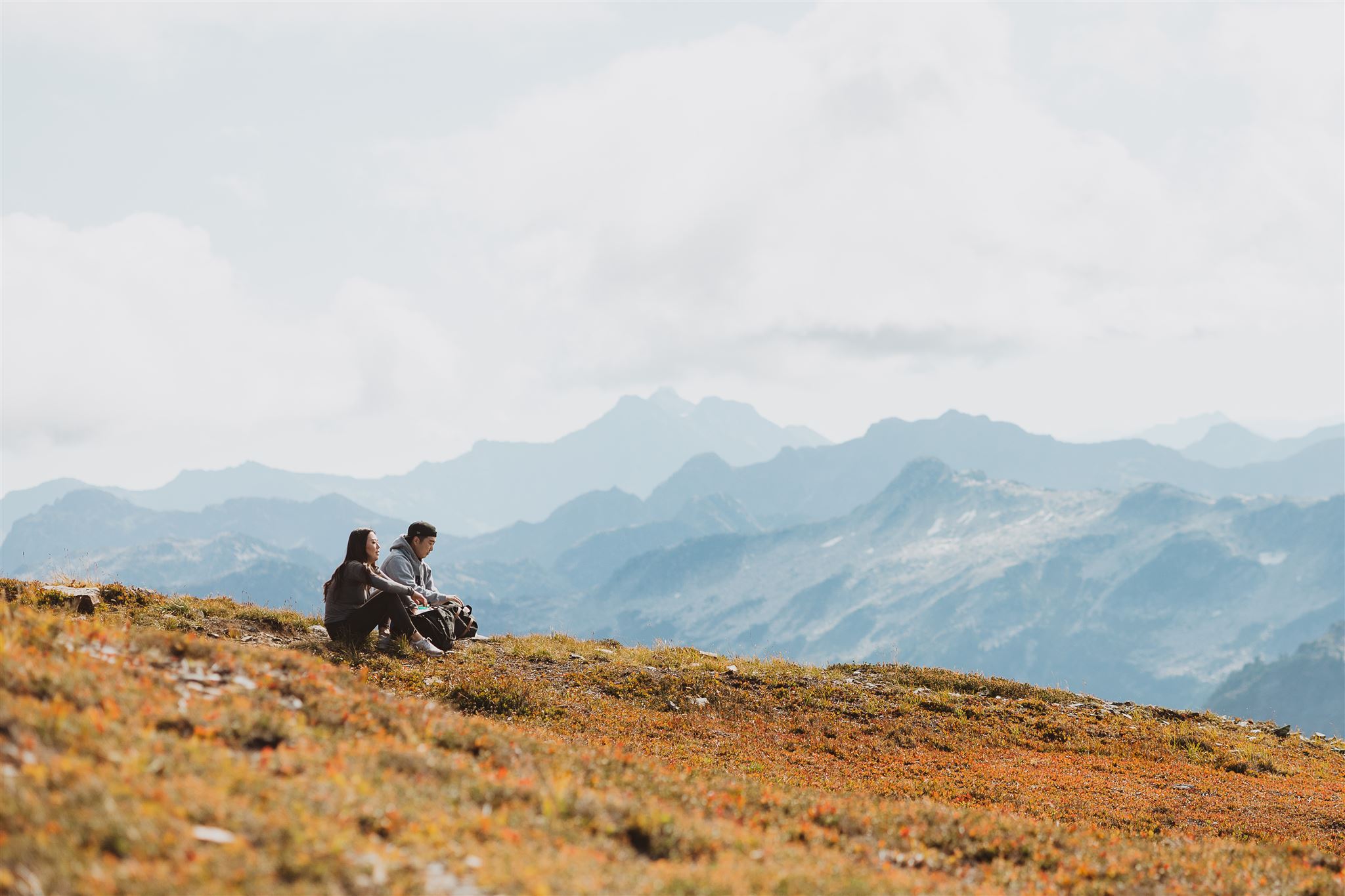 couple taking a break and enjoying the view during their hike in chilliwack