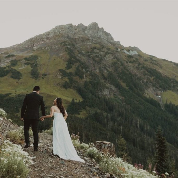 Couple hiking through a meadow on their elopement in Chilliwack, BC.